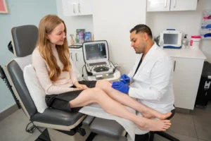 Dr. Ryan Sadloo performing a minimally invasive vein treatment on a patient at the Stamford vein clinic