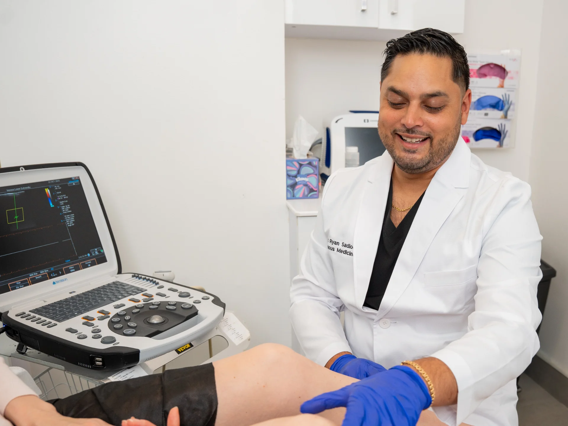 Dr. Ryan Sadloo performs a clinical examination on a patient's leg