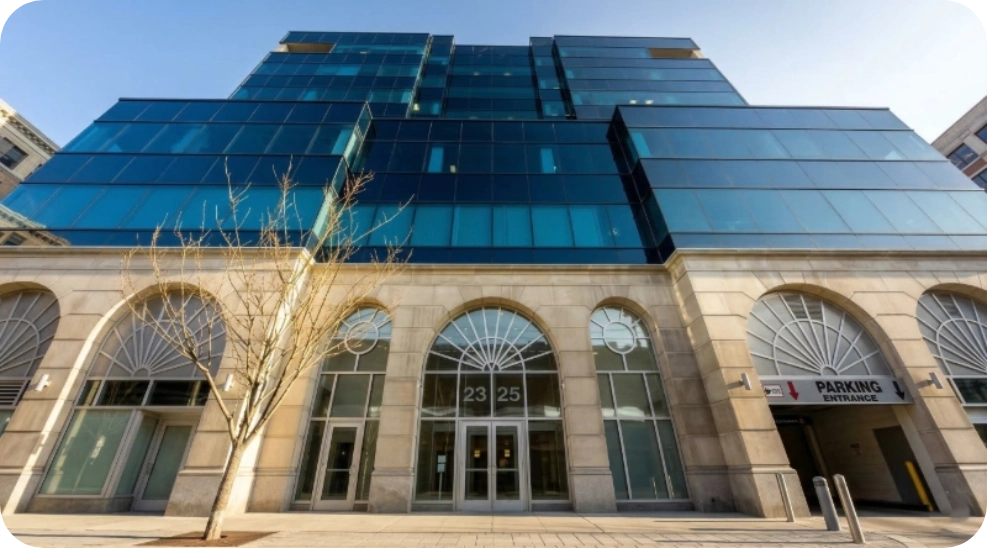 Exterior view of Vein Treatment Clinic Astoria, a modern medical office building under a clear blue sky.